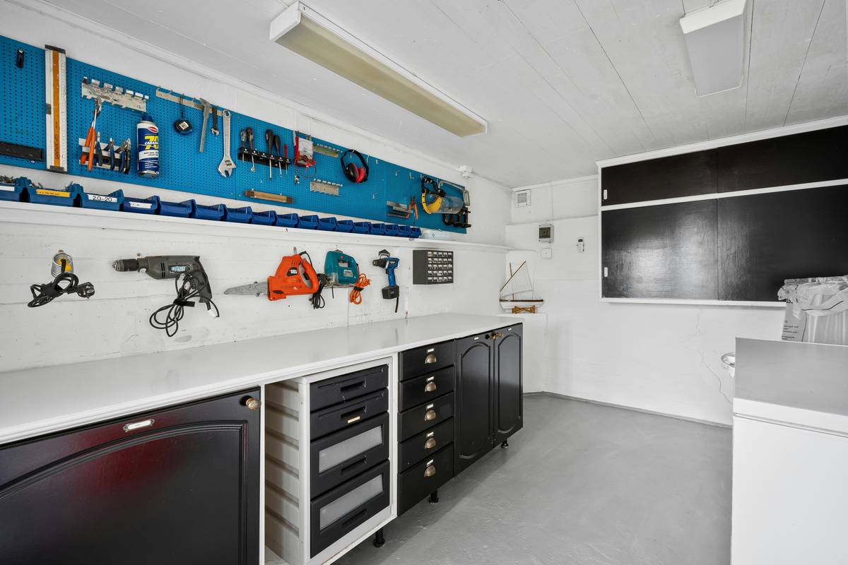 summit tools rolling tool box with fully extended drawers and organized sockets on a garage workbench