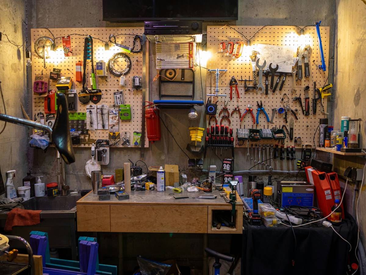 large rolling tool chest parked in a well-lit garage with drawers partially open showing organized sockets and hand tools