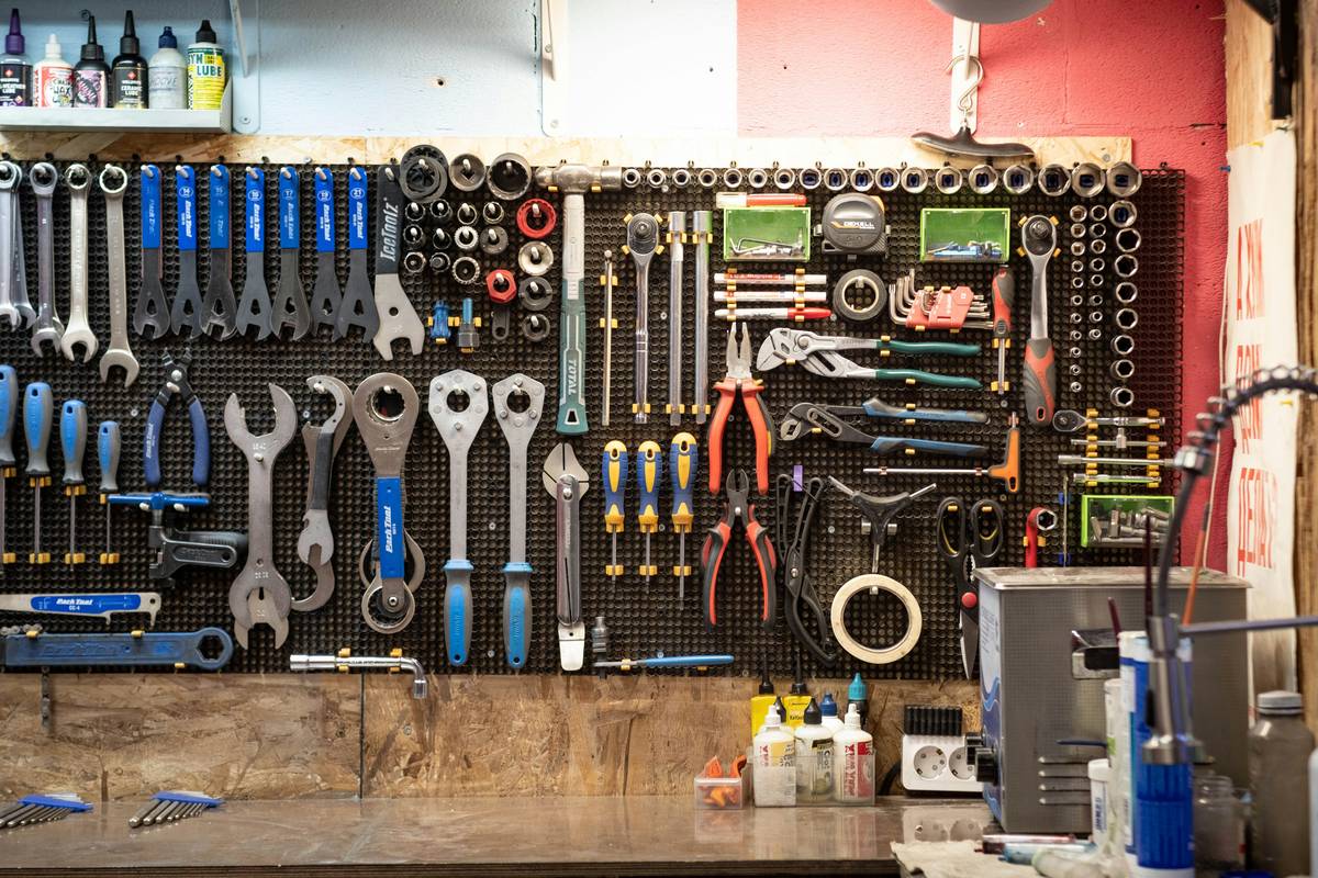 kms tools rolling tool box with open drawers showing organized sockets and wrenches in a home garage setting
